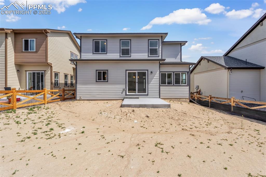 Image 42 of 43: Back of house featuring a patio area and a gate