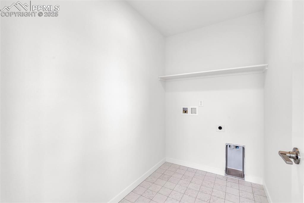 Image 6 of 43: Washroom with washer hookup, electric dryer hookup, and light tile patterne