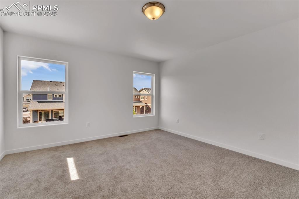 Image 8 of 43: Carpeted empty room with baseboards