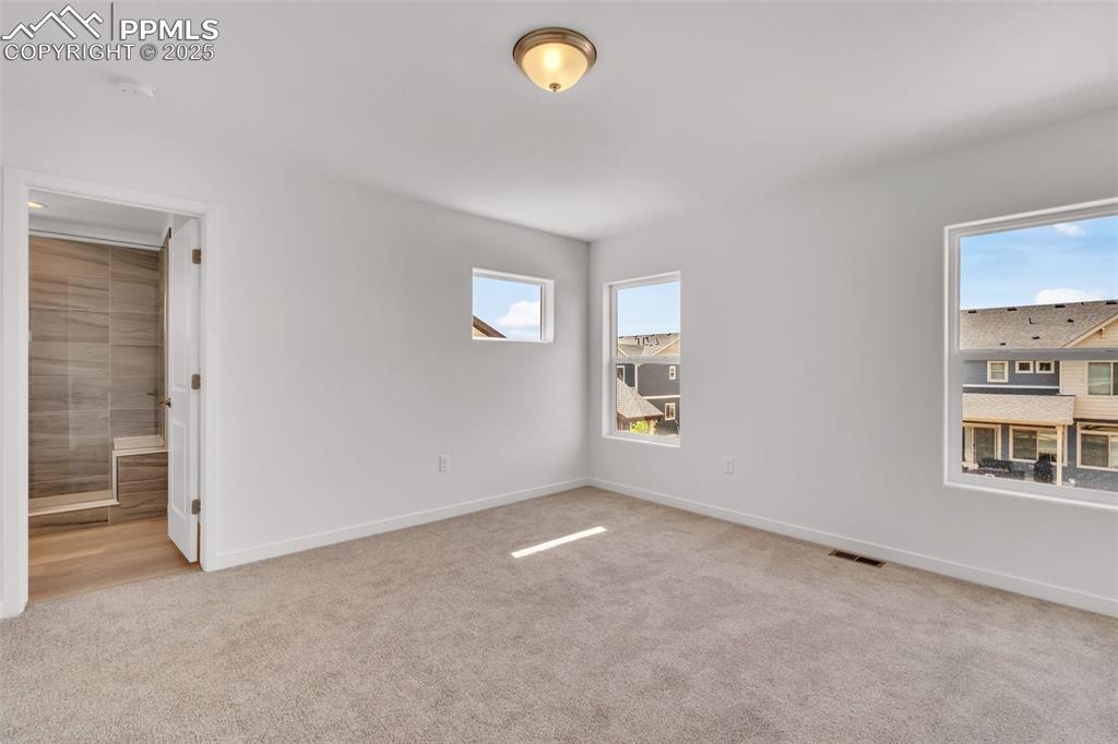 Image 9 of 43: Spare room with light carpet and baseboards
