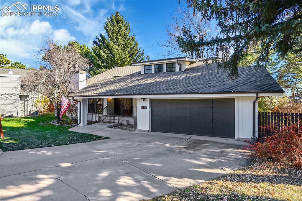 Image 2 of 43: View of front of property featuring roof with shingles, driveway, covered p