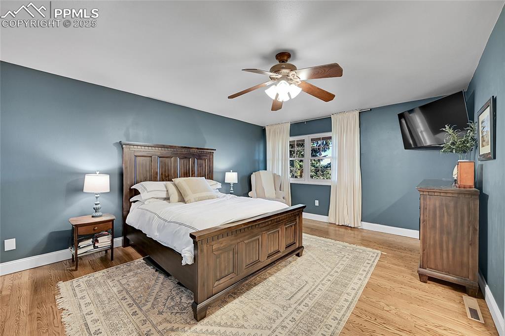 Image 24 of 43: Bedroom featuring light wood-style flooring and ceiling fan