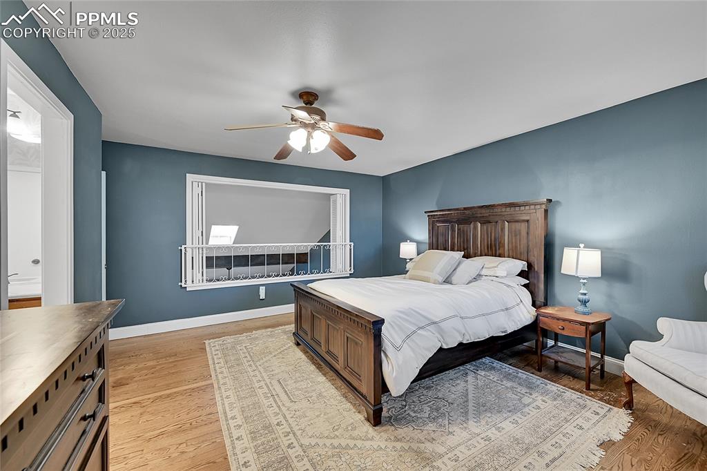 Image 26 of 43: Bedroom with light wood-style floors and a ceiling fan