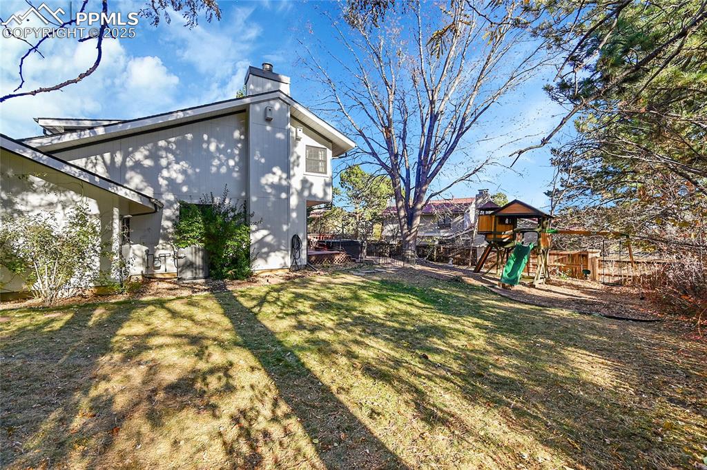 Image 37 of 43: View of yard with a playground