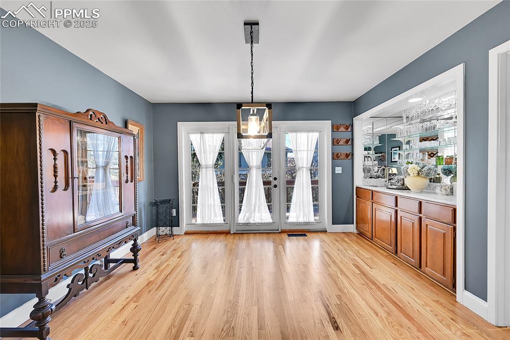 Image 8 of 43: Unfurnished dining area with light wood finished floors and a chandelier