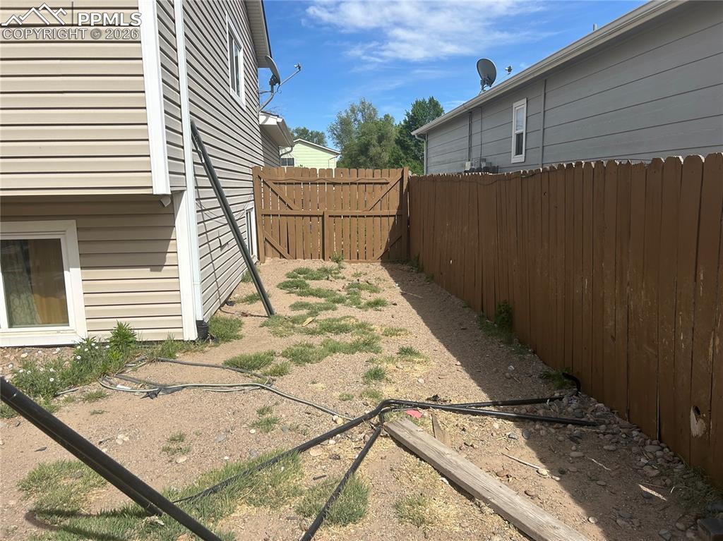 Image 6 of 10: Back yard side yard