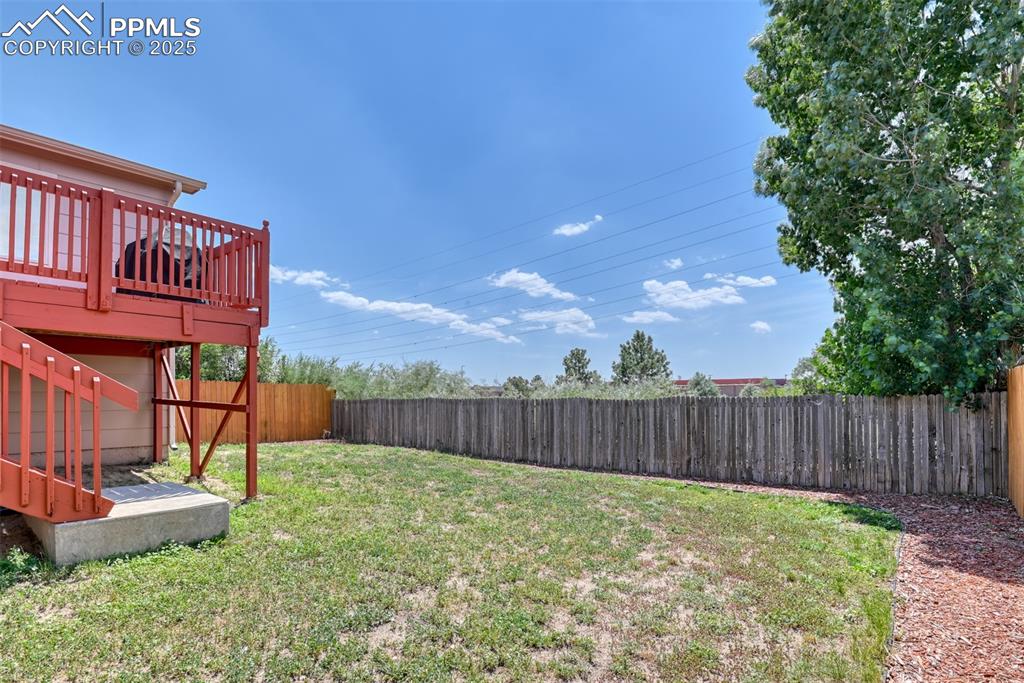 Image 19 of 46: Fenced backyard featuring a deck