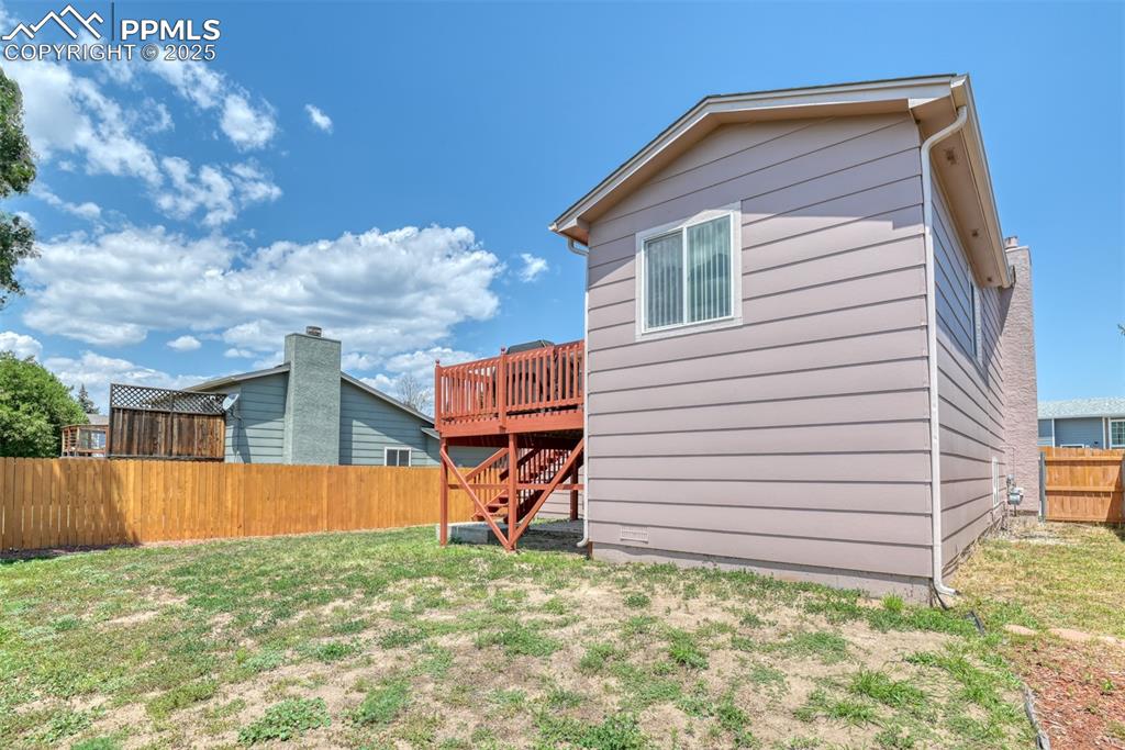 Image 21 of 46: Rear view of house featuring stairs and a deck