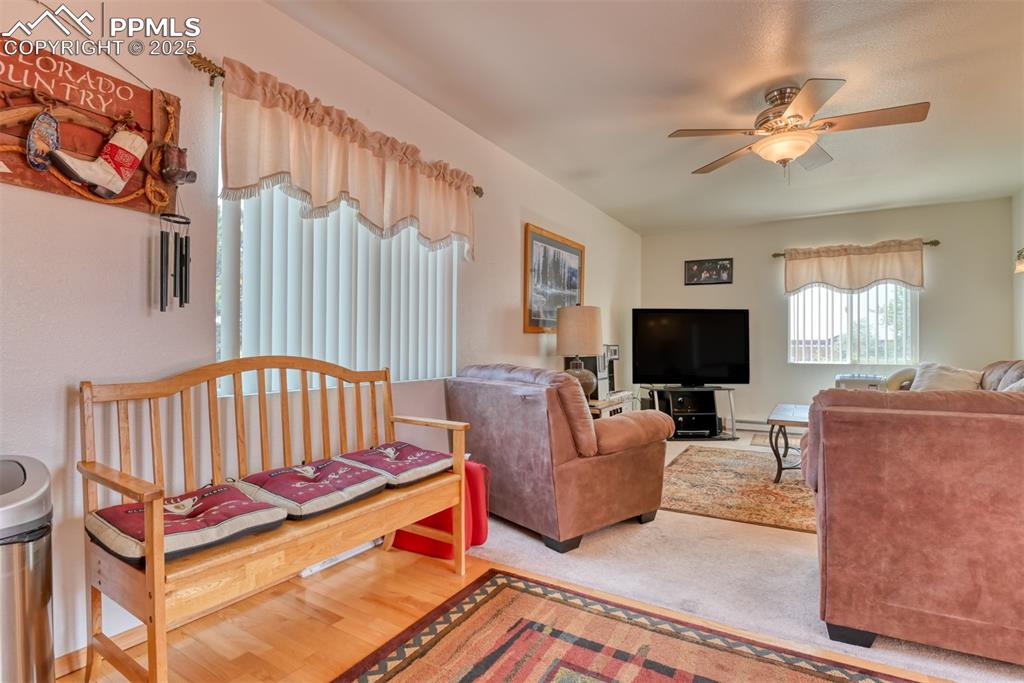Image 24 of 46: Living room with a ceiling fan