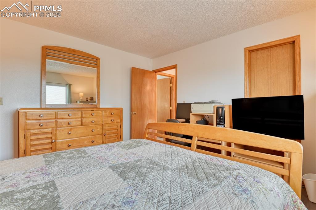 Image 31 of 46: Bedroom with a textured ceiling