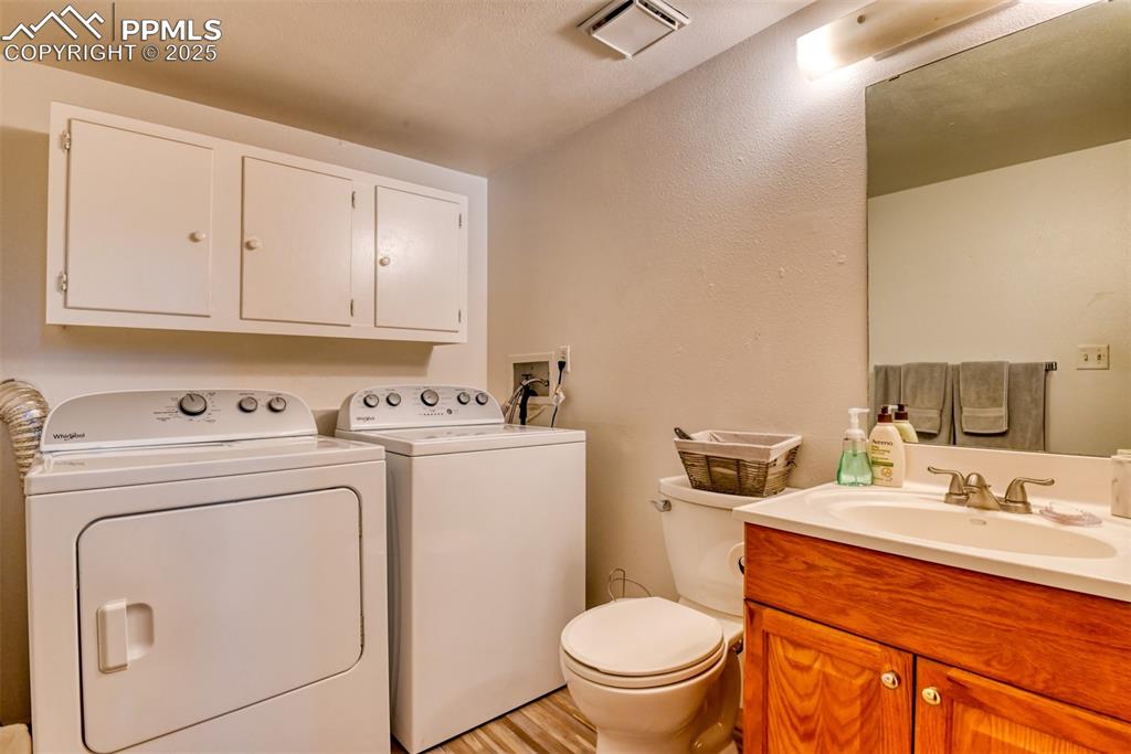 Image 39 of 46: Laundry and half bath on lower level