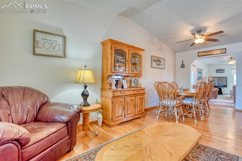 Image 8 of 46: Oprn floor plan from sitting room to kitchen and dining area.