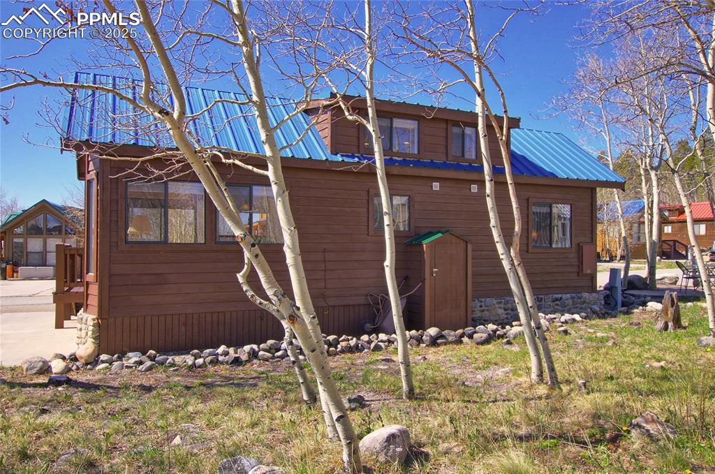 Image 7 of 50: Rear Exterior With Attached Shed