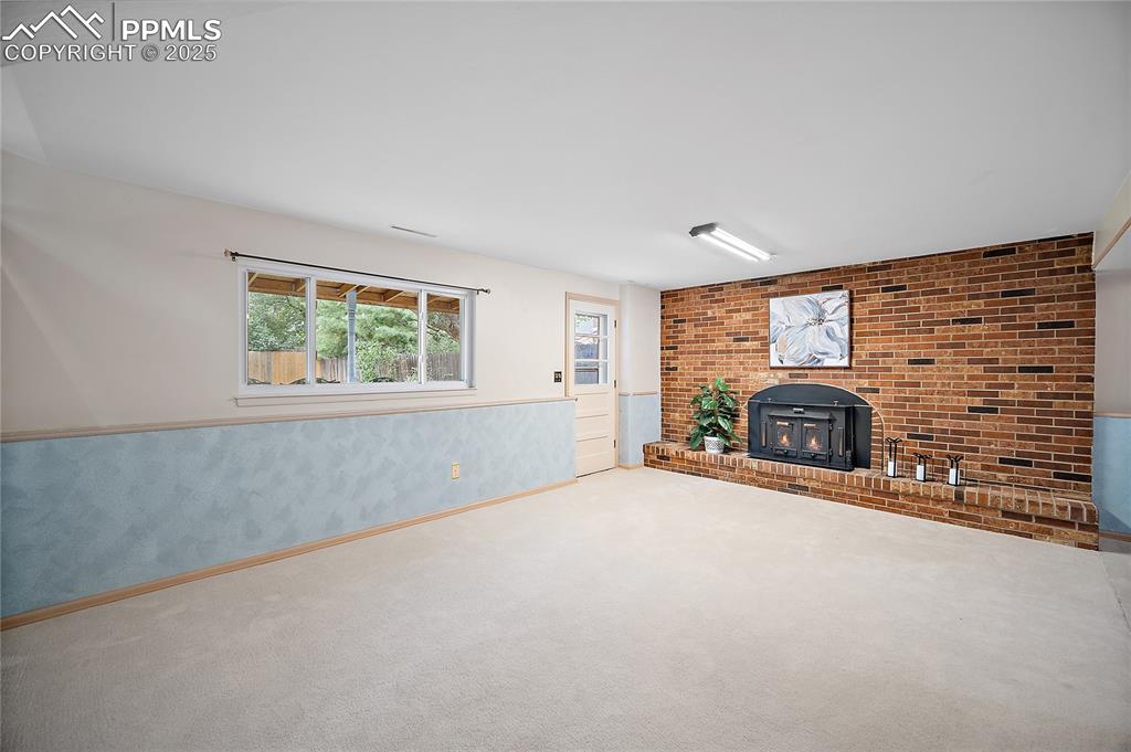 Image 22 of 41: Walk out to back yard. Wood burning stove. 