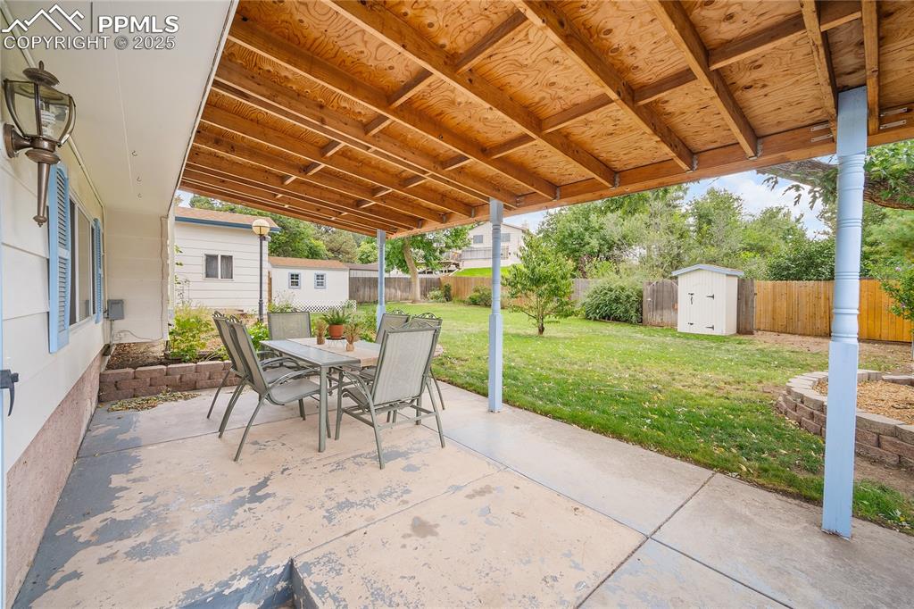 Image 29 of 41: Covered patio and large fully fenced back yard. 