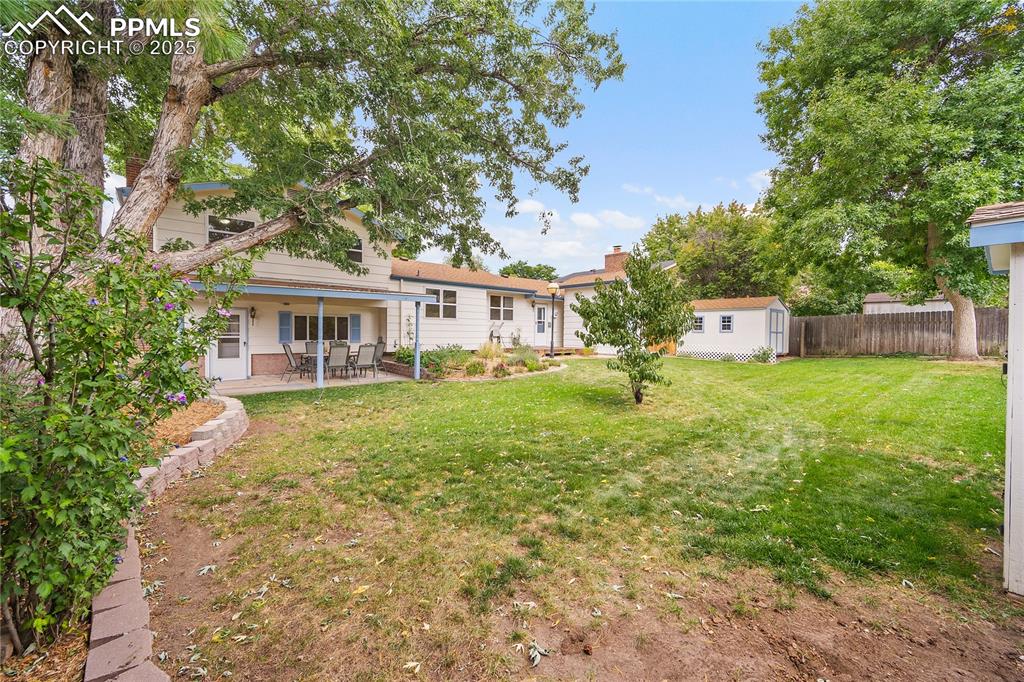 Image 30 of 41: Mature trees and manicured lawn. 