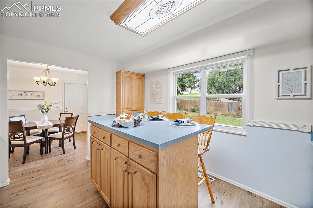 Image 9 of 41: Kitchen island with breakfast bar and addtional storage. 