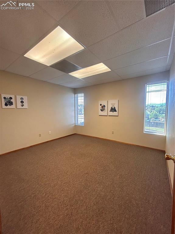 Image 10 of 45: Carpeted empty room with a drop ceiling