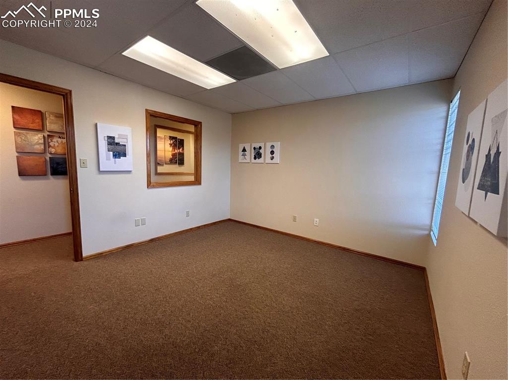 Image 11 of 45: Carpeted spare room with a drop ceiling