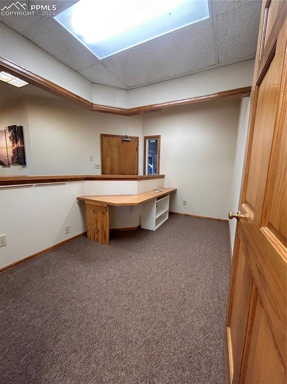Image 17 of 45: Unfurnished office with a paneled ceiling and carpet