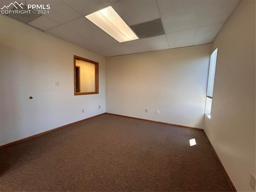 Image 2 of 45: Carpeted empty room featuring a paneled ceiling