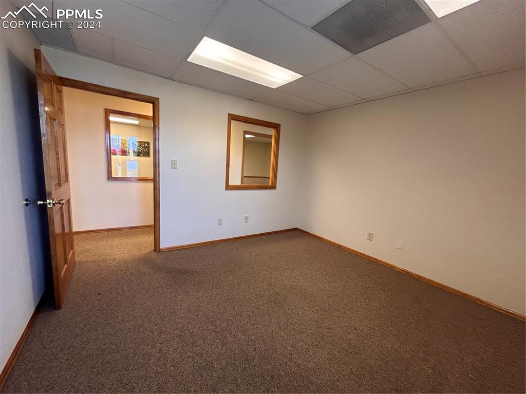 Image 25 of 45: Carpeted spare room with a paneled ceiling