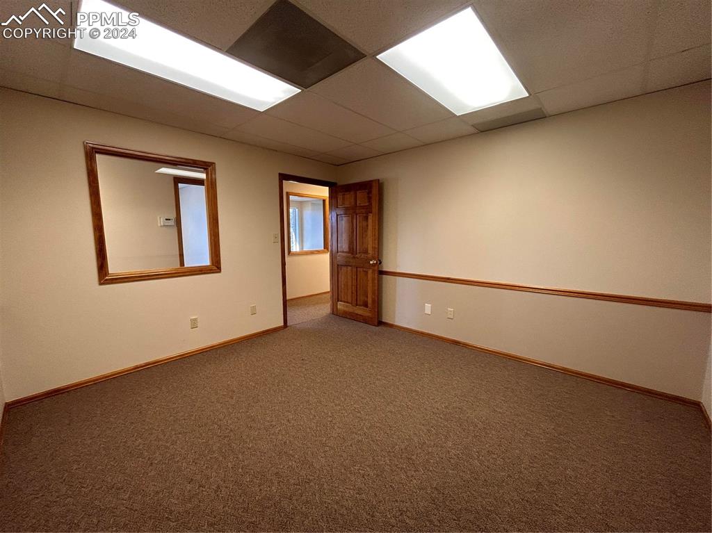 Image 28 of 45: Carpeted spare room featuring a paneled ceiling