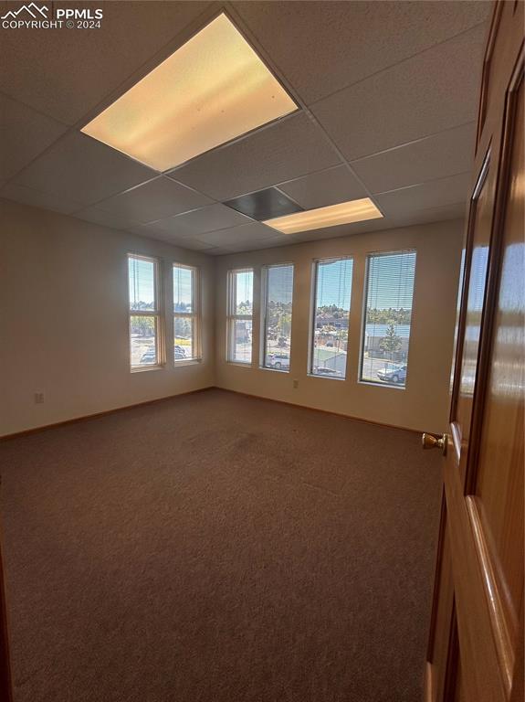 Image 29 of 45: Carpeted empty room with a paneled ceiling