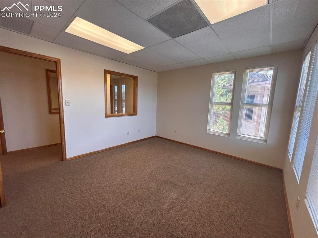 Image 30 of 45: Carpeted spare room featuring a drop ceiling
