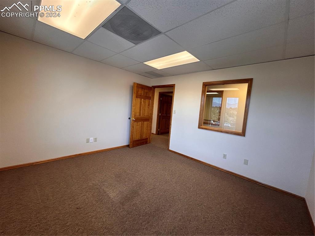 Image 31 of 45: Unfurnished room with carpet floors and a drop ceiling