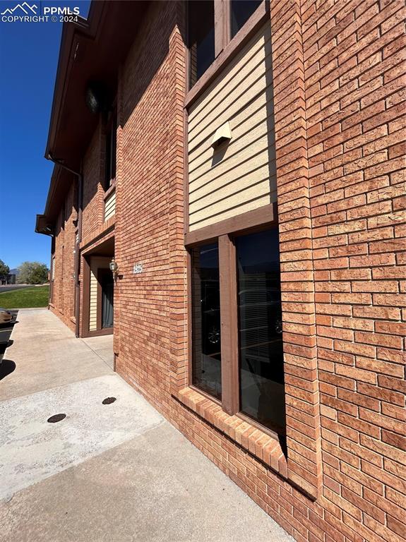 Image 49 of 49: View of side of property featuring a patio