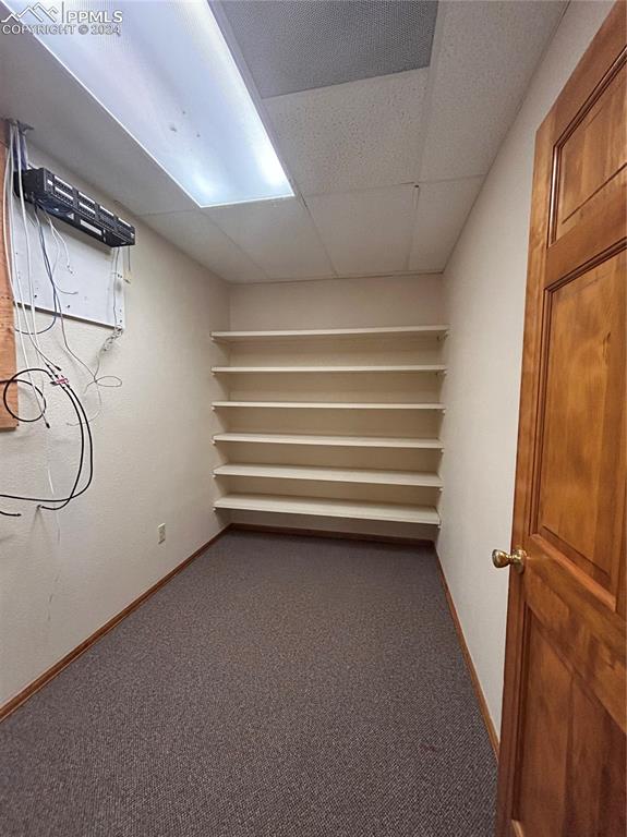 Image 7 of 45: Unfurnished room with a drop ceiling and carpet flooring