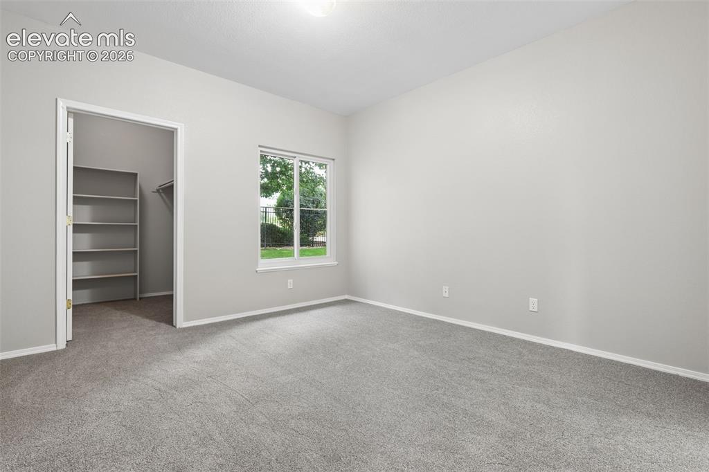 Image 14 of 27: Carpeted room featuring a single window, an overhead light fixture, and a c
