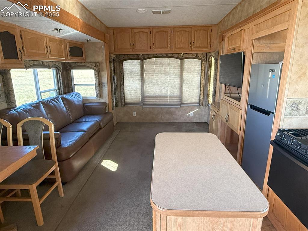 Image 11 of 15: Living area with carpet