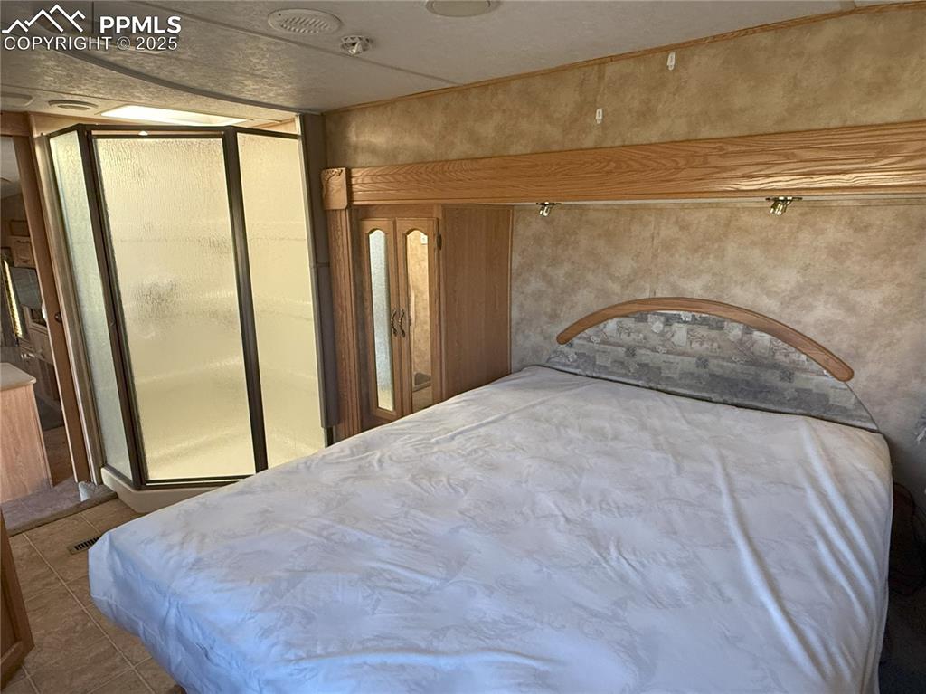 Image 14 of 15: Bedroom featuring tile patterned floors