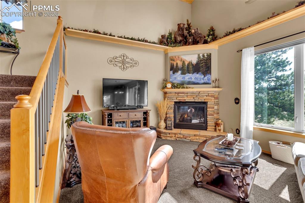 Image 15 of 44: Gas fireplace with a gorgeous hearth and rock surround