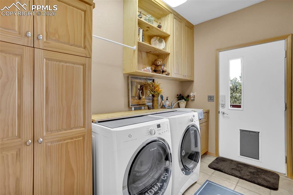 Image 22 of 44: Main level laundry room with door to deck