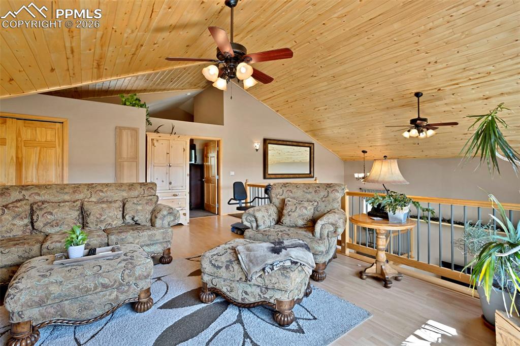 Image 23 of 44: Upper level loft/2nd living room, notice the pine vaulted ceilings!