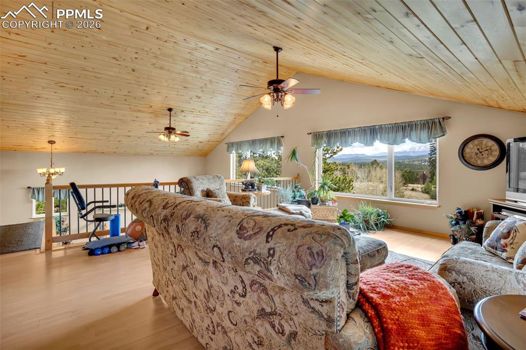Image 26 of 44: Upper level loft, with door to upper deck shared with the Primary bedroom