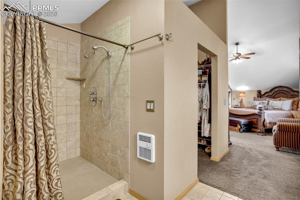 Image 31 of 44: Primary bathroom, 5 pc with a fully tiled walk-in shower and walk-in closet