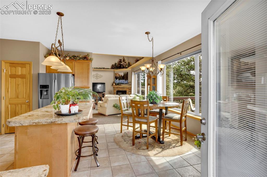 Image 4 of 44: Door from deck, eat-in nook in the kitchen