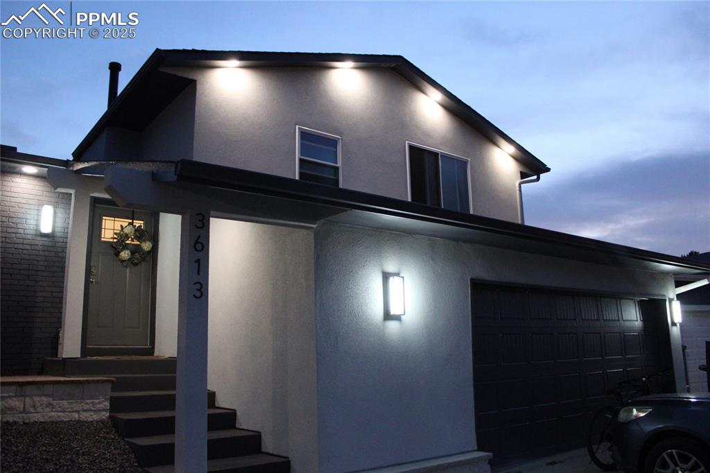 Caption: View of front of house with stucco siding
