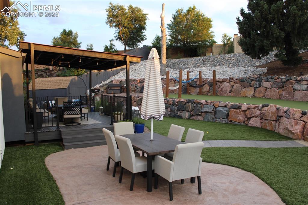 Image 17 of 26: View of patio / terrace with outdoor dining area and a wooden deck