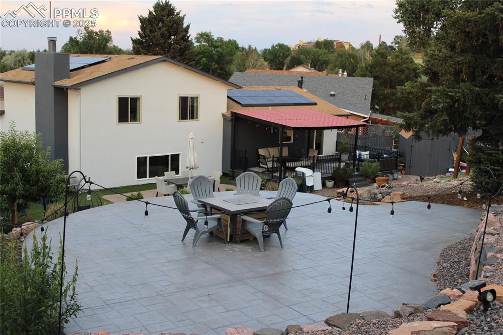 Image 26 of 26: View of patio featuring a storage unit and outdoor dining space