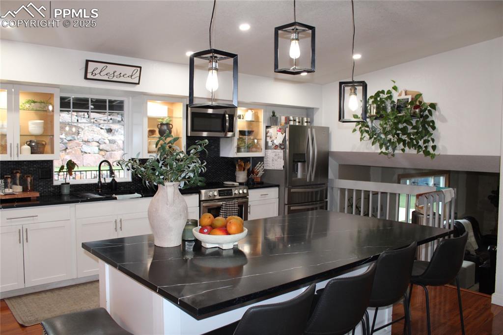 Image 9 of 26: Kitchen featuring wood finished floors, appliances with stainless steel fin