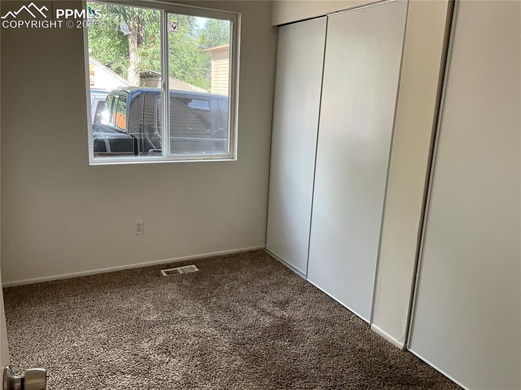 Image 11 of 13: Unfurnished bedroom featuring carpet floors and a closet