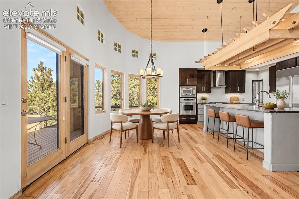 Image 14 of 50: Virtually Staged
Open-concept living space with wood-finish flooring, a cu