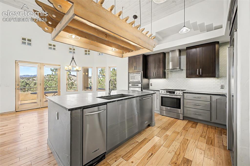 Image 17 of 50: Gourmet kitchen with stainless steel appliances, a center island featuring 