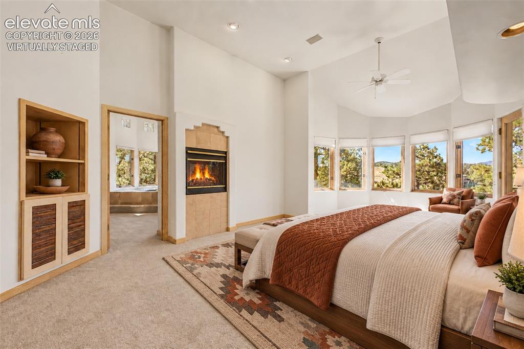 Image 24 of 50: Virtually Staged
Built-in shelving, tiled fireplace, vaulted ceiling, bay