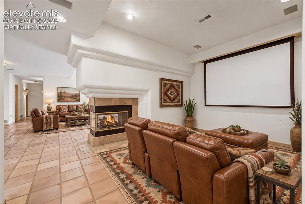 Image 36 of 50: Virtually Staged
Recessed lighting, a built-in media screen, and a two-sid
